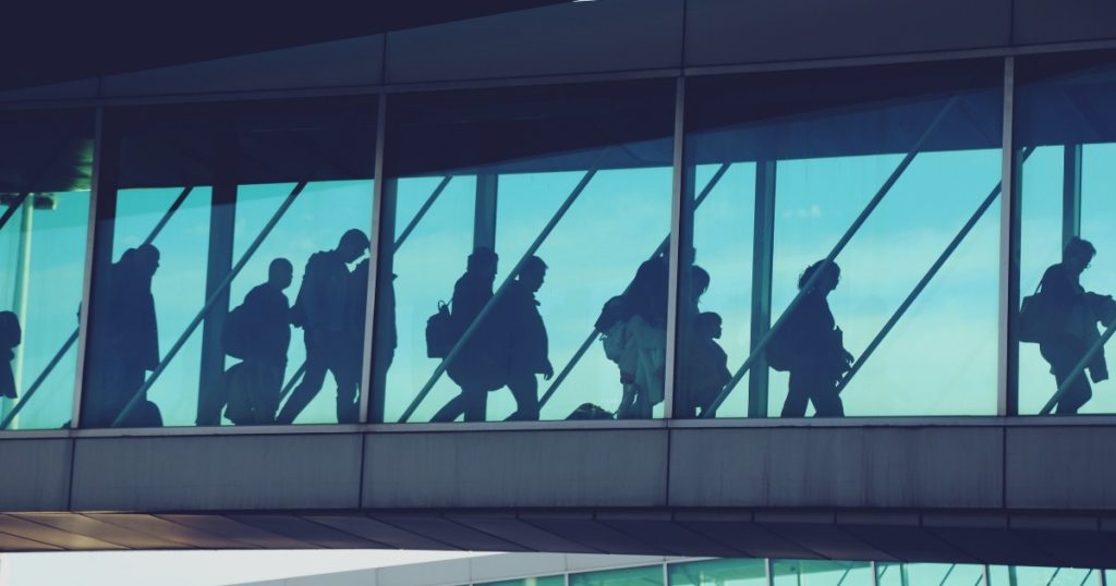 Airport terminal departure area with travellers preparing for flights
