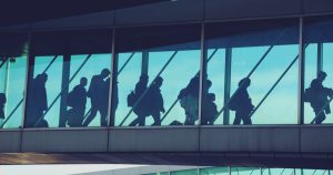 Airport terminal departure area with travellers preparing for flights