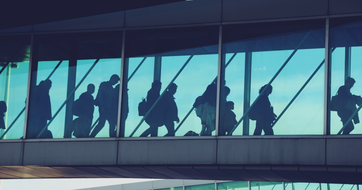 Airport terminal departure area with travellers preparing for flights