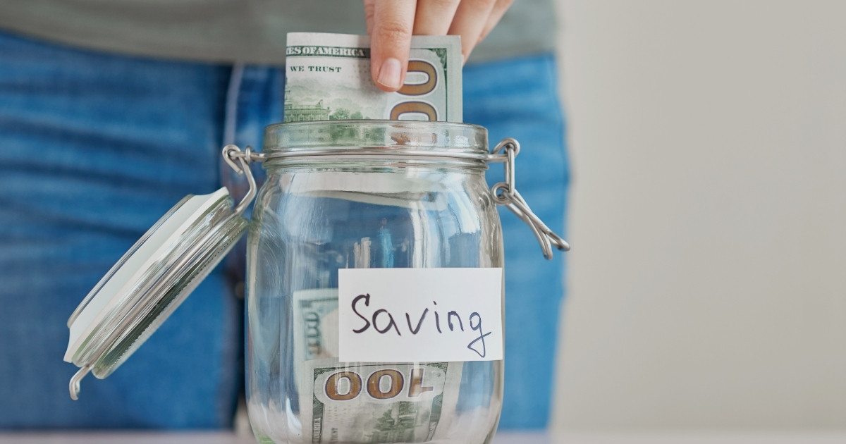 Saving money in a jar for travel budget planning